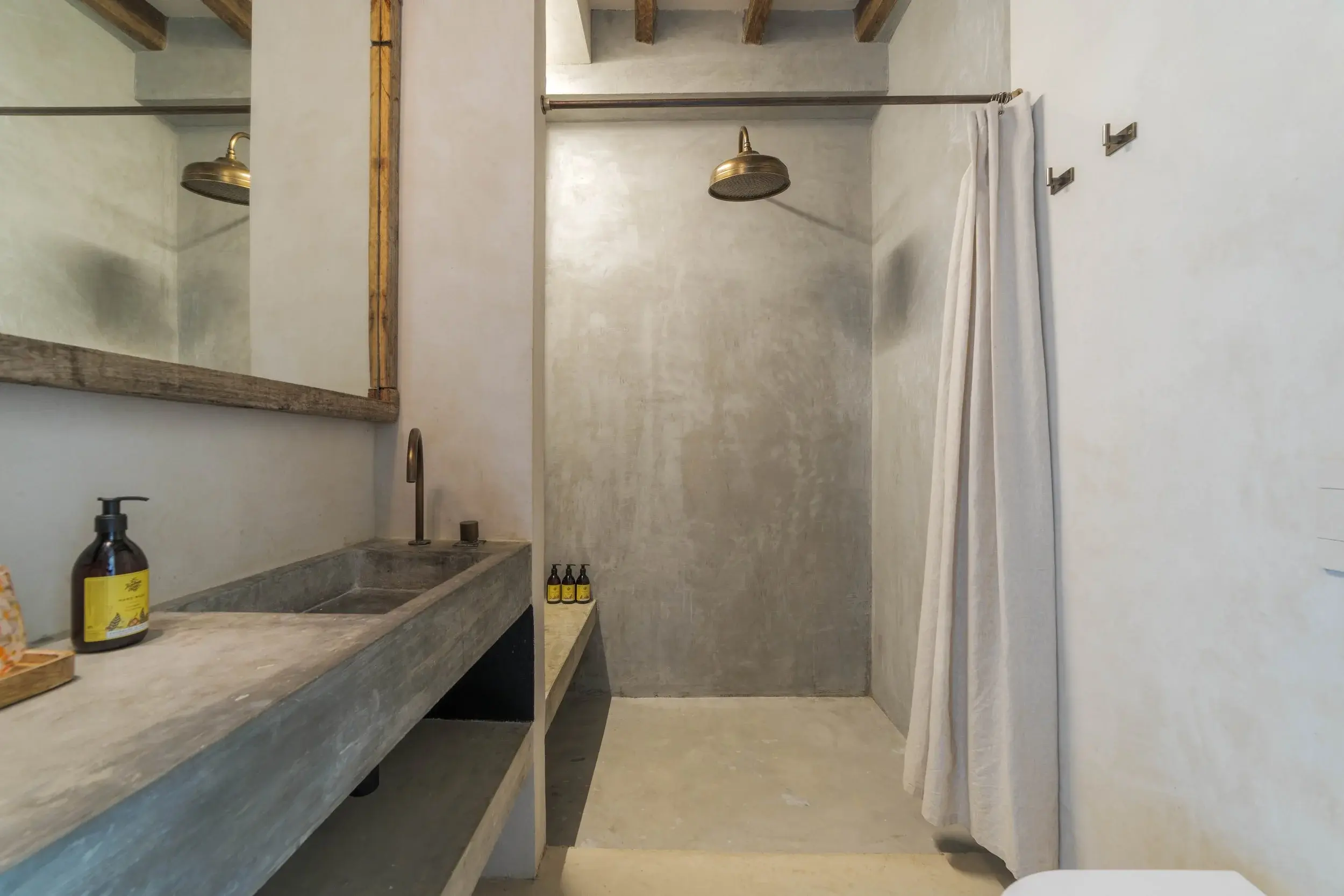Walk-in shower and concrete vanity in an en suite bathroom