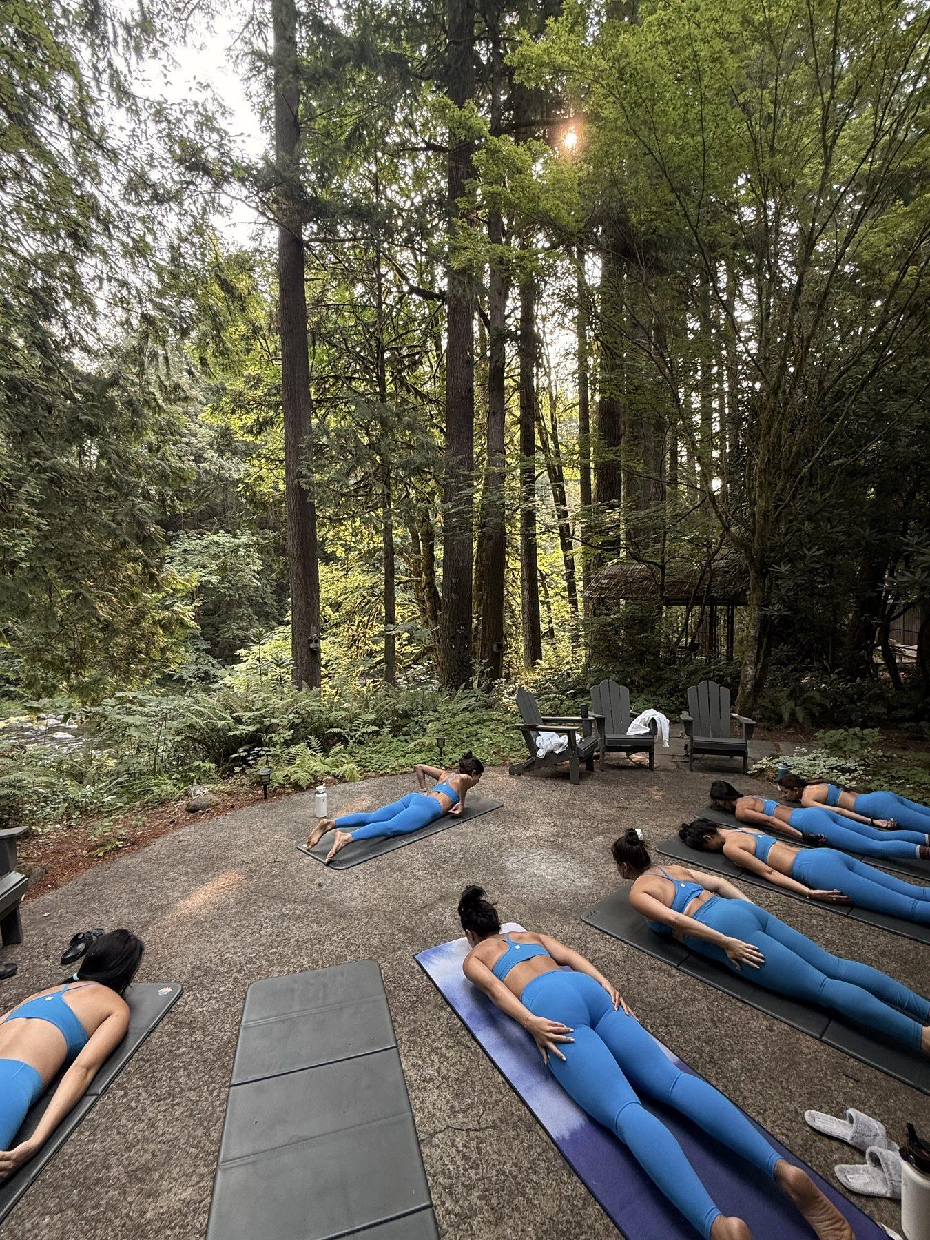A bachelorette group taking a private mat Pilates class together outdoors